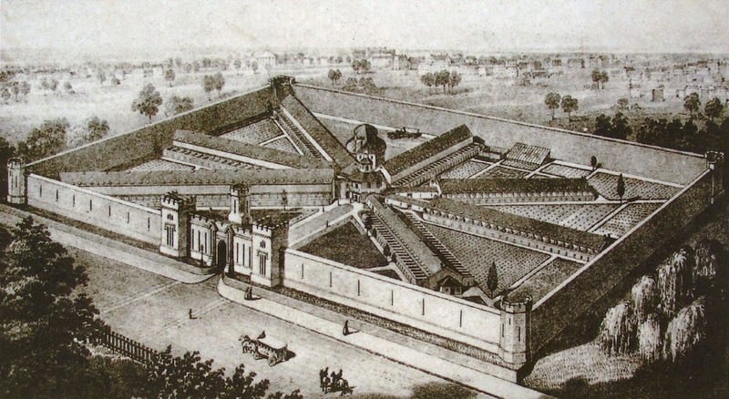 A lithograph depicting a walled-in building, viewed from above. Seven hallways stem from a central point inside the walls similar to the spokes on a wheel. A large, castle-like gate serves as the entrance through the high exterior walls.