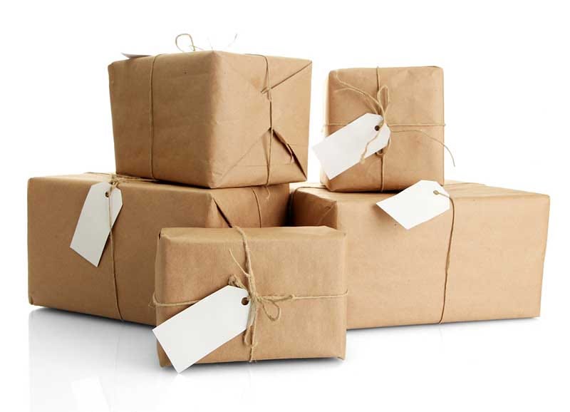 Collection of wrapped parcels with delivery tags.
