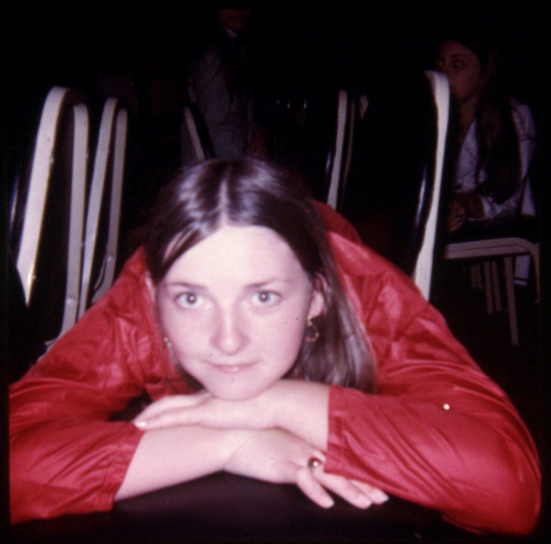 Photograph of Ann McIlhargey lying on chairs in the ballroom of the Silver Springs Maryland Holiday Inn sometime in May of 1972.