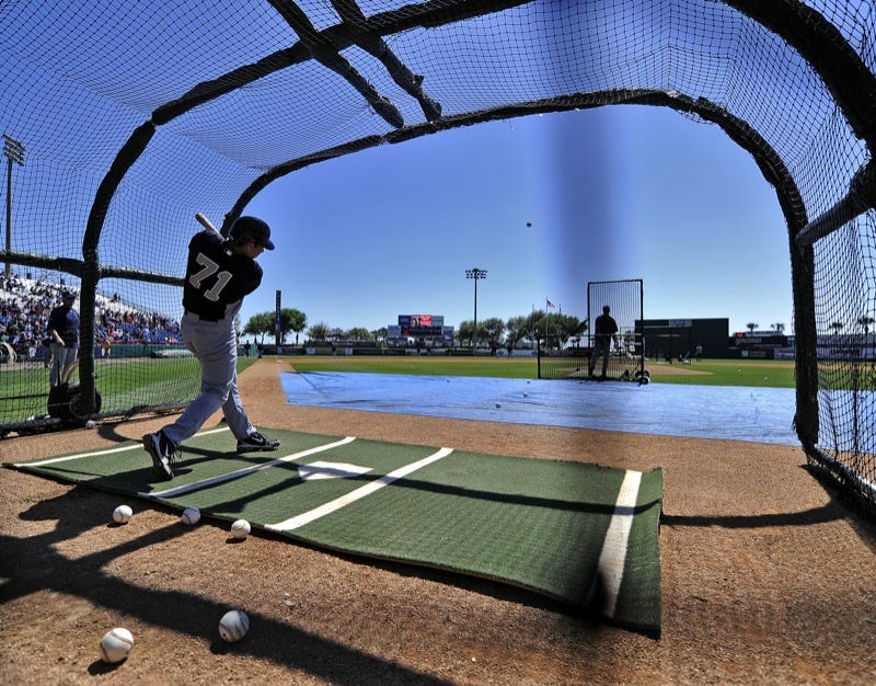 A baseball player taking batting practice