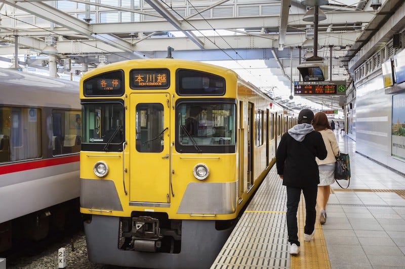 A yellow train at Hon-Kawagoe Station in Saitama Prefecture