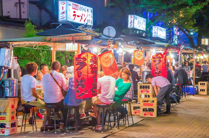 A bunch of people enjoy the outdoor food stalls in Fukuoka without tipping because there’s no such gratuity culture here