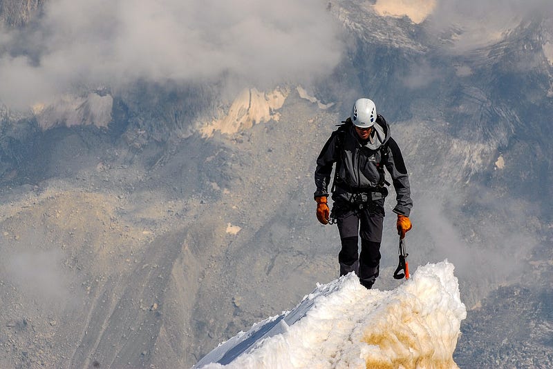 Man on top of a mountain.
