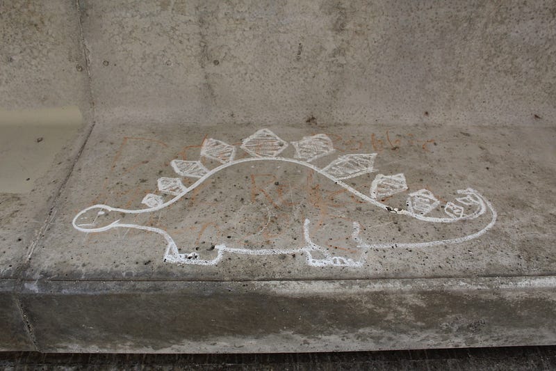 graffiti under bridge in Bellingham depicting a dinosaur