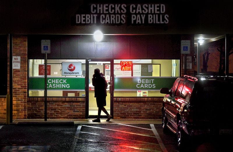 A customer leaves a payday loan store in Gaithersburg, Maryland, in February 2019. Photo by Michael S. Williamson, The Washington Post.