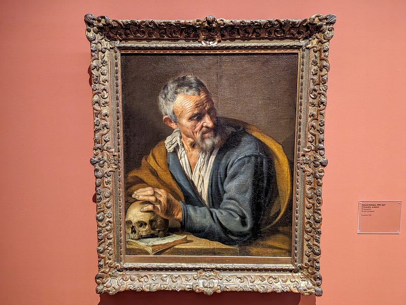 Painting of an elderly man holding a skull