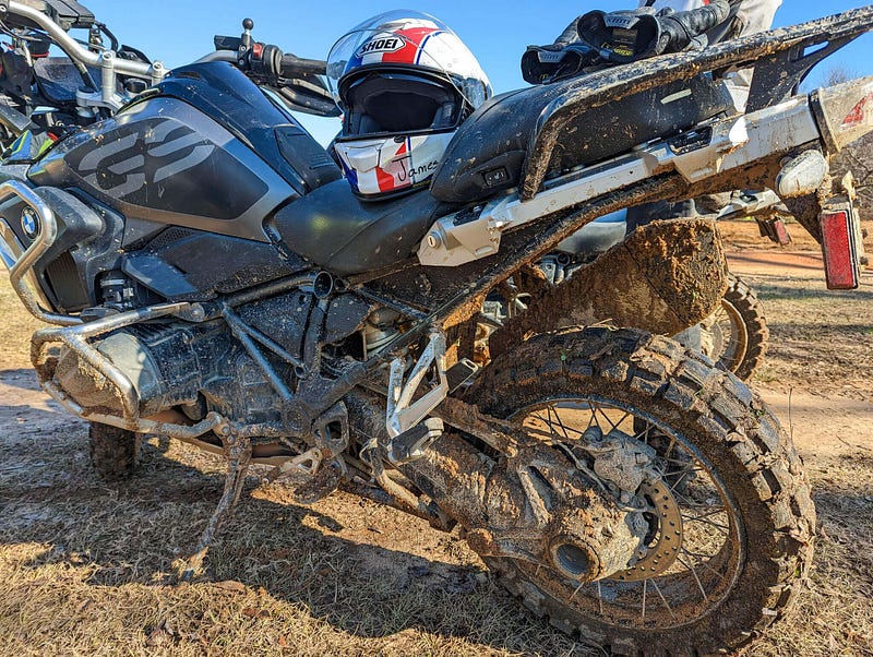 Survivor: close-up of mud-covered adventure motorcycle that’s seem some tough times