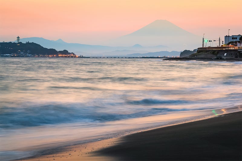 The island of Enoshima set against the backdrop of Mt. Fuji