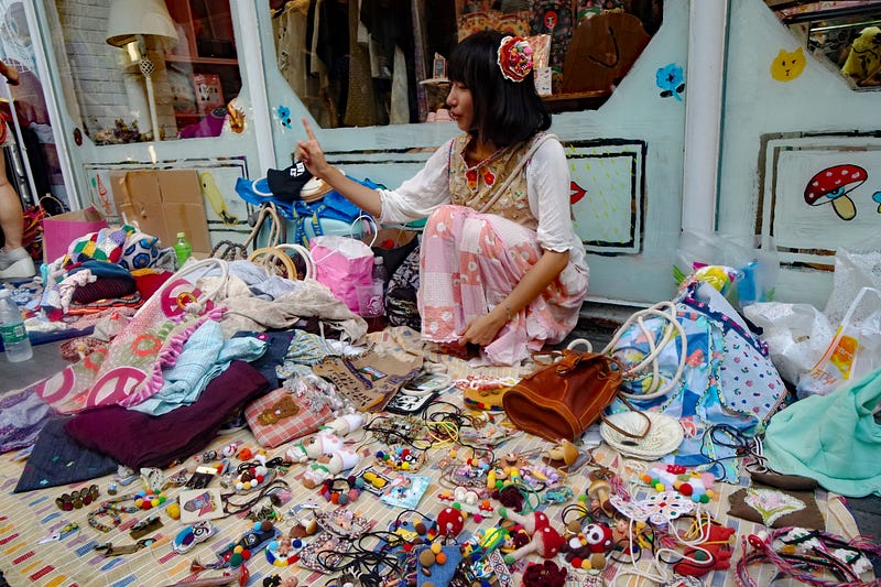 A woman who is participating in a flea market. You can see sticking to
everything
you sell