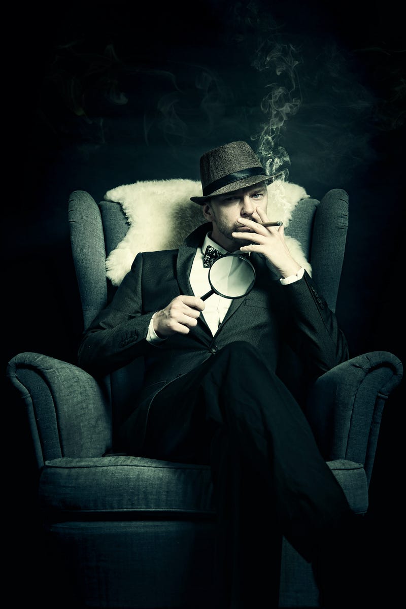 Detective sitting in chair smoking, holding magnifying glass.