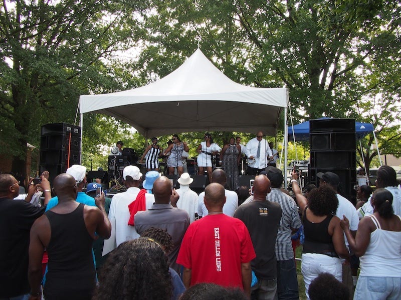 Crowd gathers and faces a stage