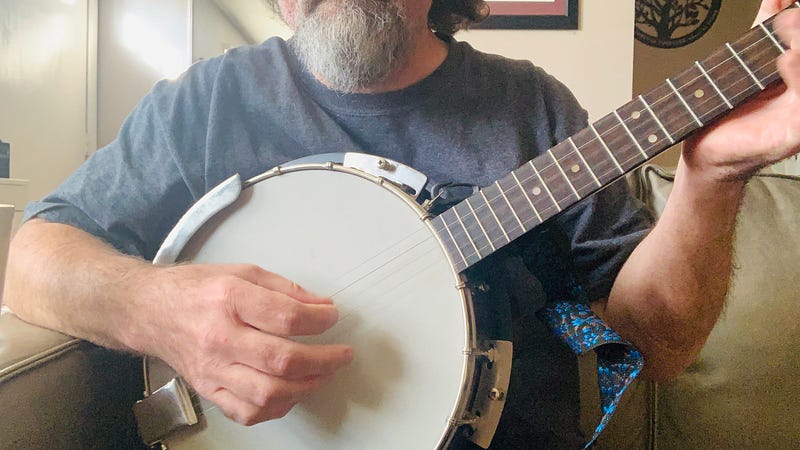 The writer, Gerard McLean, strumming a 5-string banjo.