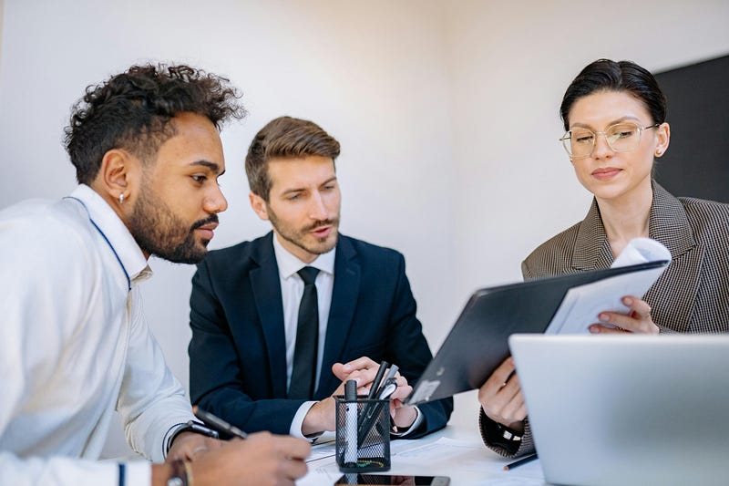 Coworkers looking at a document in a meeting.