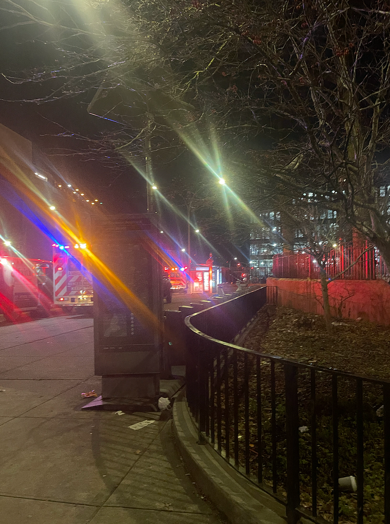 An image of ambulance lights on the city, illuminating the streets around me.