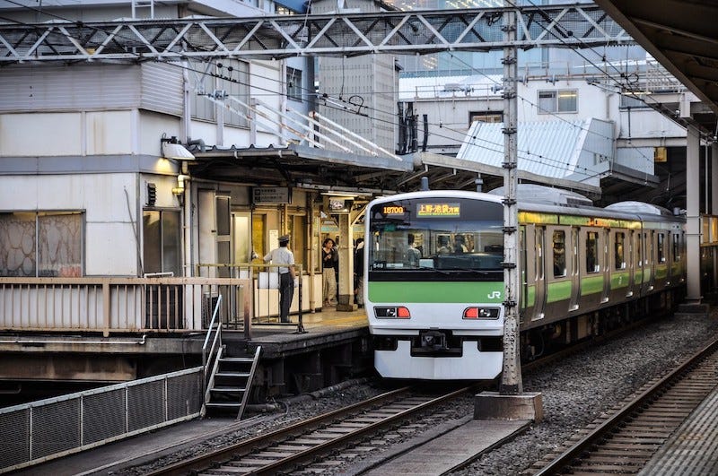 A Yamanote Line train pulls into Nippori Station near Yanaka