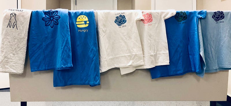 Photo of custom blue and white t-shirt designs created by downloading Noun Project icons and printing them onto the shirt