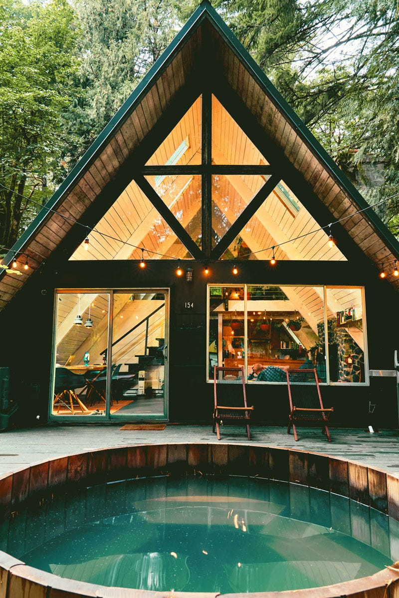 A view of an A-frame house in Packwood, Washington, including the hot tub.