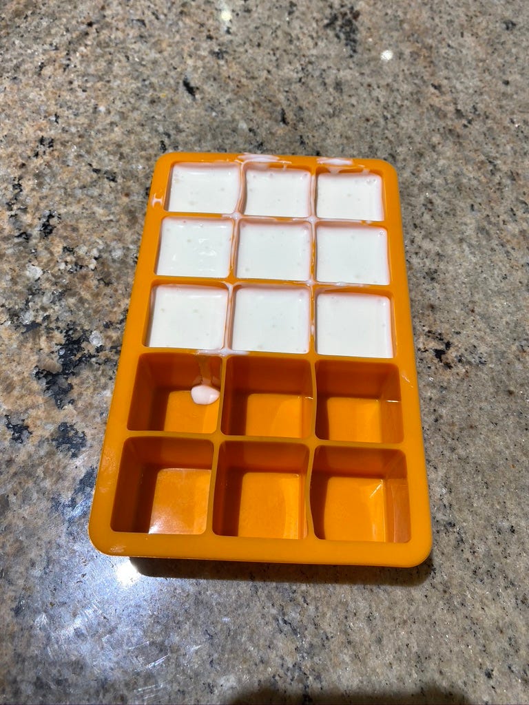 Collecting some yogurt starter for the next batches. Will freeze these and pop them into a ziploc bag — then use 1 cube at a time for additional batches.
