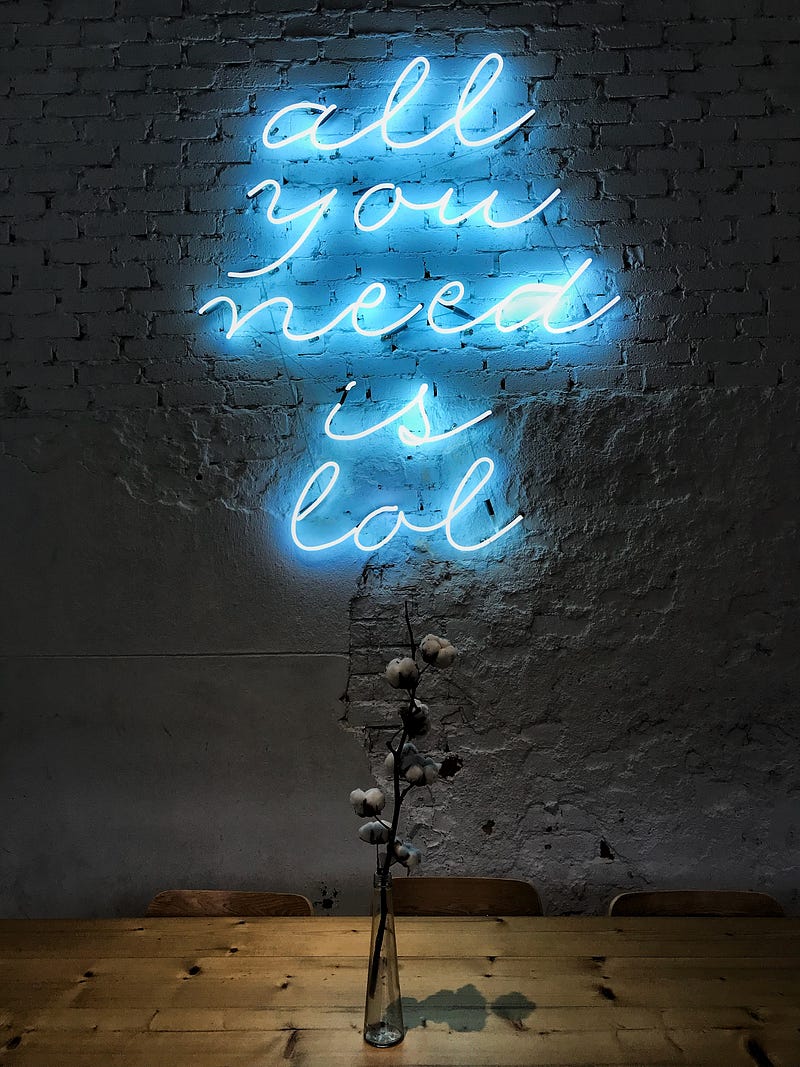 Blue neon sign saying "all you need is lol"