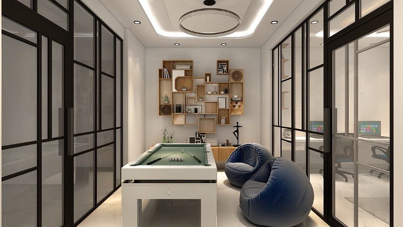 This modern indoor game lounge is designed as a stylish recreational space within a contemporary home. The area features a sleek pool table at the center, complemented by comfortable bean bag seating for relaxation and casual gatherings. Glass partitions with black metal frames create a semi-open layout while maintaining visual connectivity with adjacent spaces.