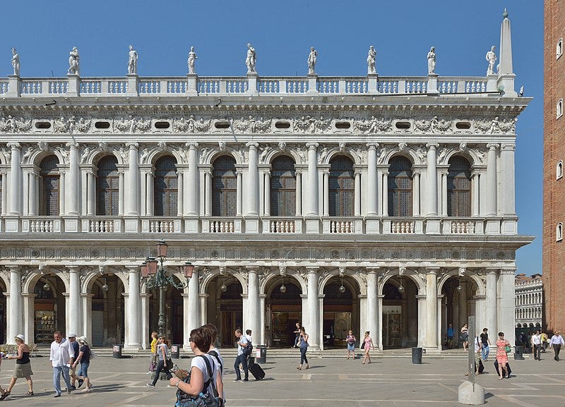 The Biblioteca Marciana in Venice, a white two-story building adorned with arches.