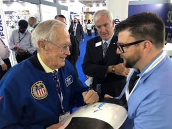 Former astronaut Charlie Duke adds his signature to the ZEVA Zero display during a visit to the Choose Washington booth. 