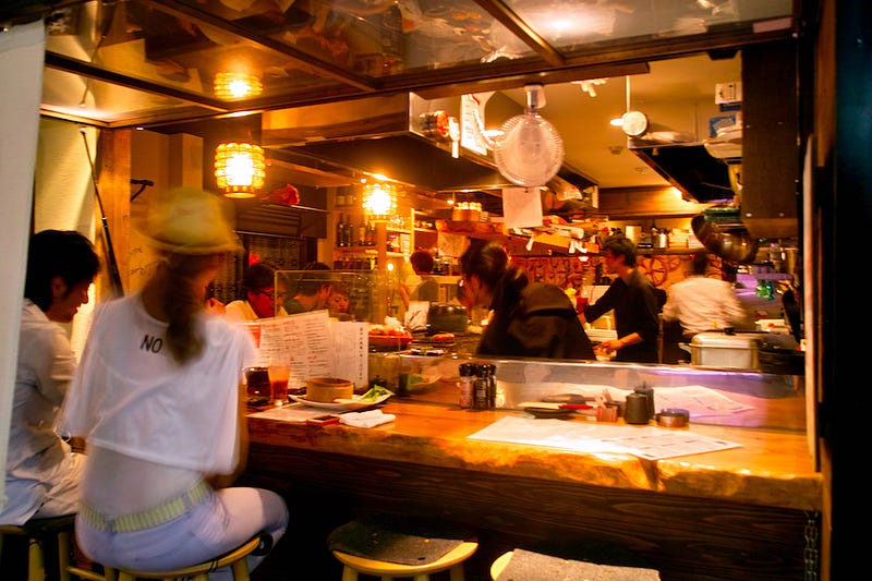 People eat out at a restaurant while enjoying drinks before a night of partying in Japan