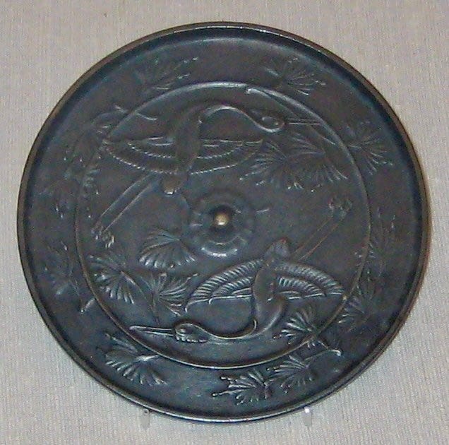 Round mirror decorated with 2 cranes.