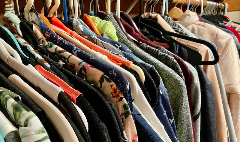 A very full wordrobe of women’s clothing.