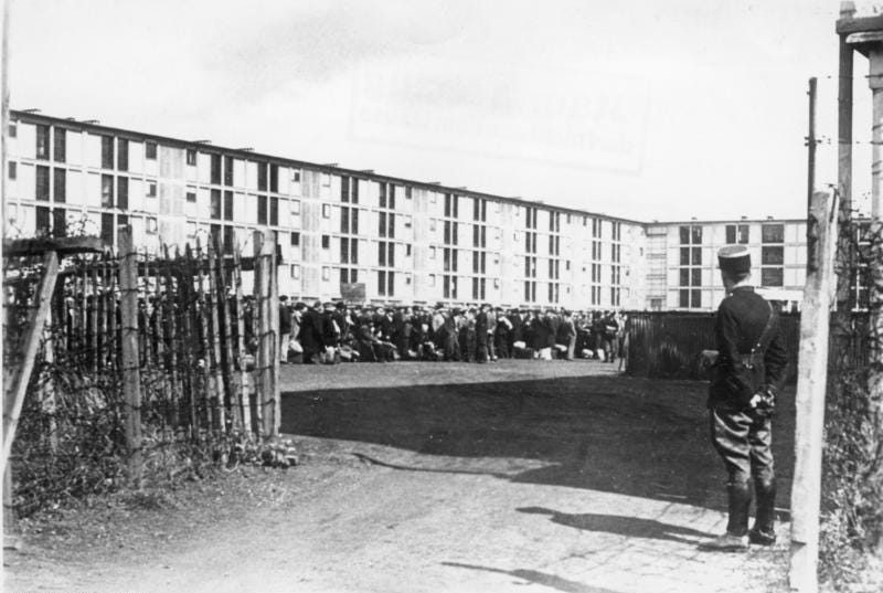 View of the Drancy transit camp outside Paris, guarded by a French gendarme officer. Bundesarchiv, Germany