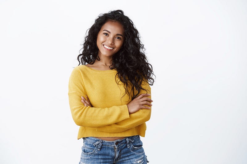 Happiness, wellbeing and confidence concept. cheerful attractive african american woman curly haircut, cross arms chest in self-assured powerful pose, smiling determined, wear yellow