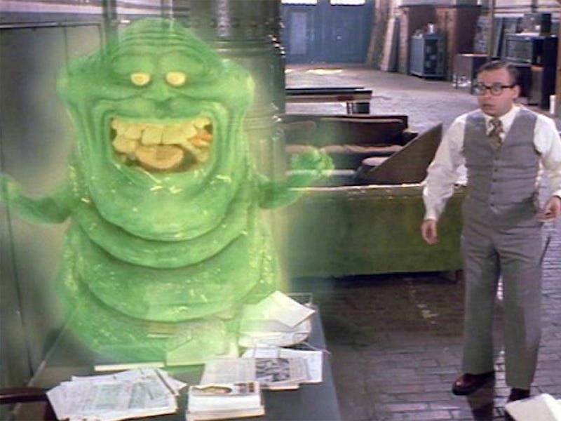 A still from Ghostbusters II, used as part of a montage showing the characters back in business and busy. Originally part of a much larger sub-plot between Louis Tully (Rick Moranis) and Slimer, this brief vignette shows Slimer stealing food before being frightened by (and frightening) Louis — with both of them fleeing in opposite directions.