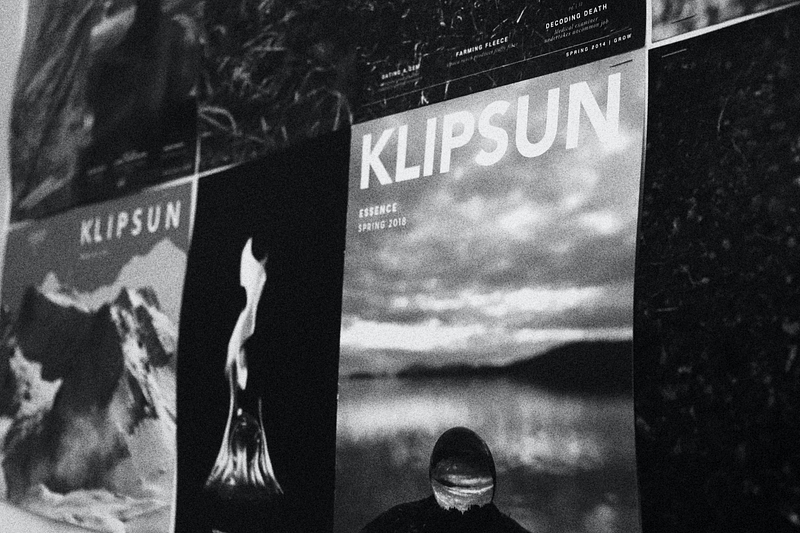 A close-up of Klipsun’s Essence cover from 2018, which shows a clear marble in front of a lake and a marble in a fire.