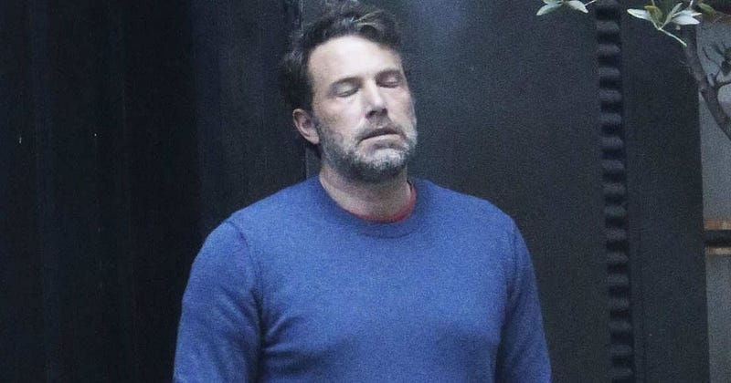 Ben affleck smoking, looking tired.