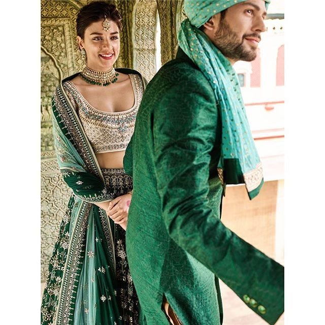 Bride and groom in green color coordinated outfits