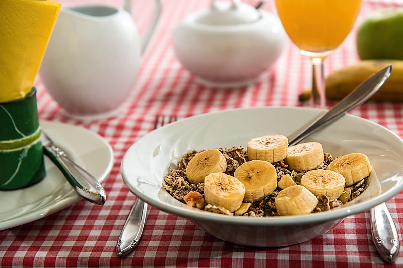 A bowl of wheat flakes with banana.