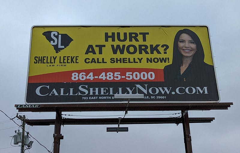 Lawyer billboard advertisement “Hurt at Work? Call Shelly Now!”