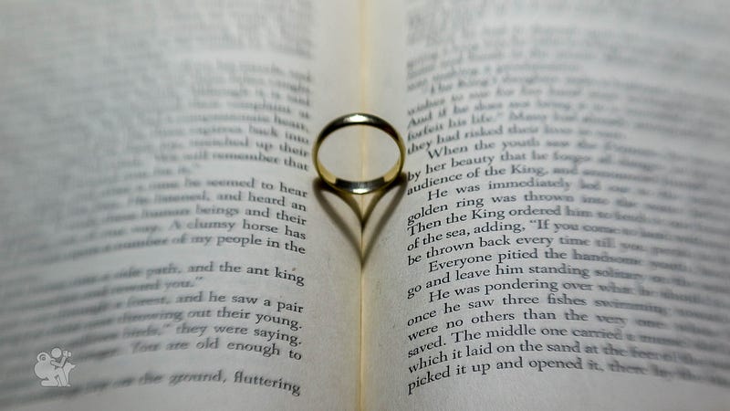 a golden wedding ring casts a heart shaped shadow in a book of fairy tails a golden wedding ring casts a heart shaped shadow in a book of fairy tails