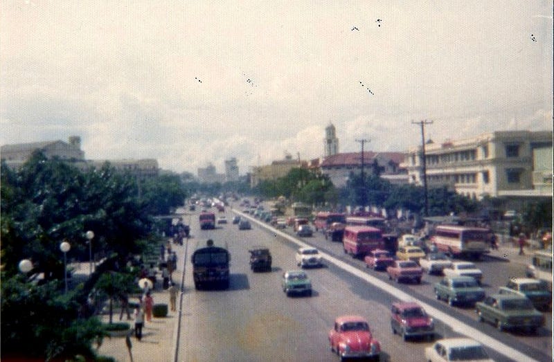 Wide Manila street with traffic.