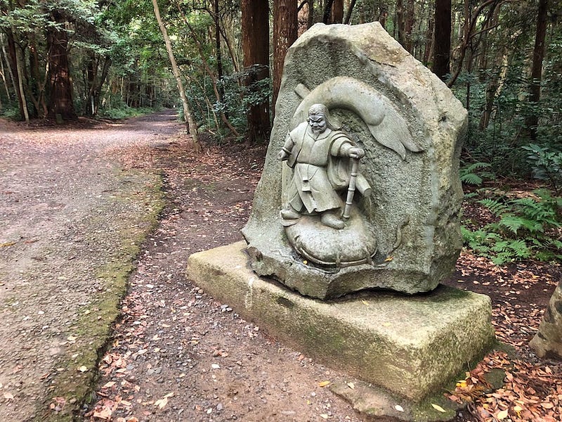 A statue of the deity Takemikazuchi pinning the catfish Namazu at Ibaraki Prefecture’s Kashima Jingu