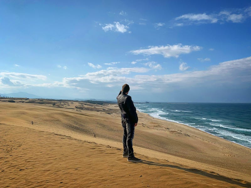 Donny Kimball stands on top of the Tottori Sand Dunes and looks out at the sea