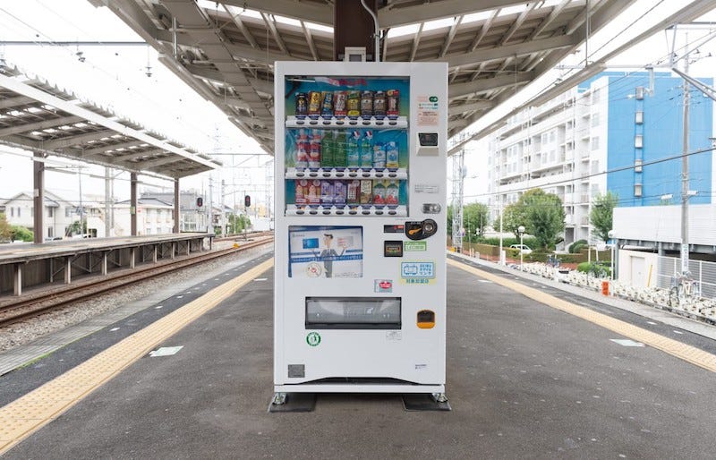 A vending machine sits on a train station platform in central Tokyo