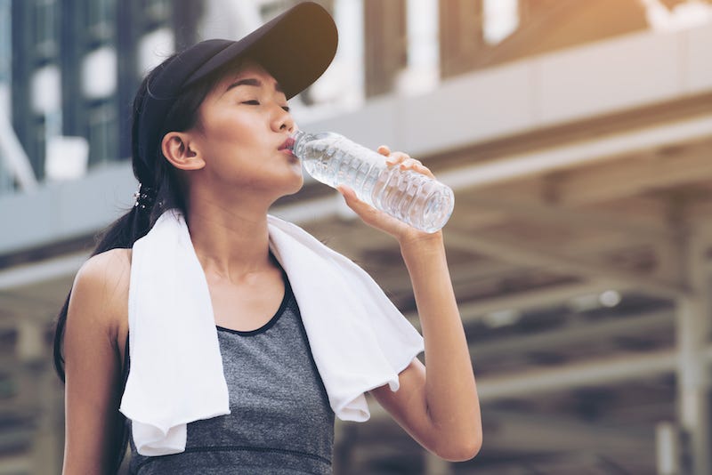 A woman in Japan rehydrates after working out during summer