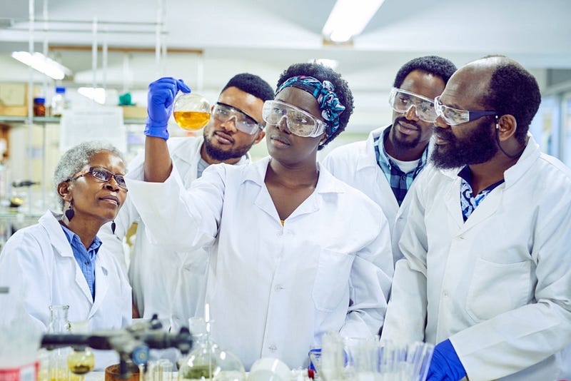 Shot of a group of scientists working together in a lab. | @Moyo Studio