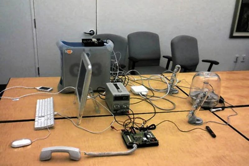 Picture of the early non form factor prototype of the iphone. On the table are visible different components of the device that are not integrated.
