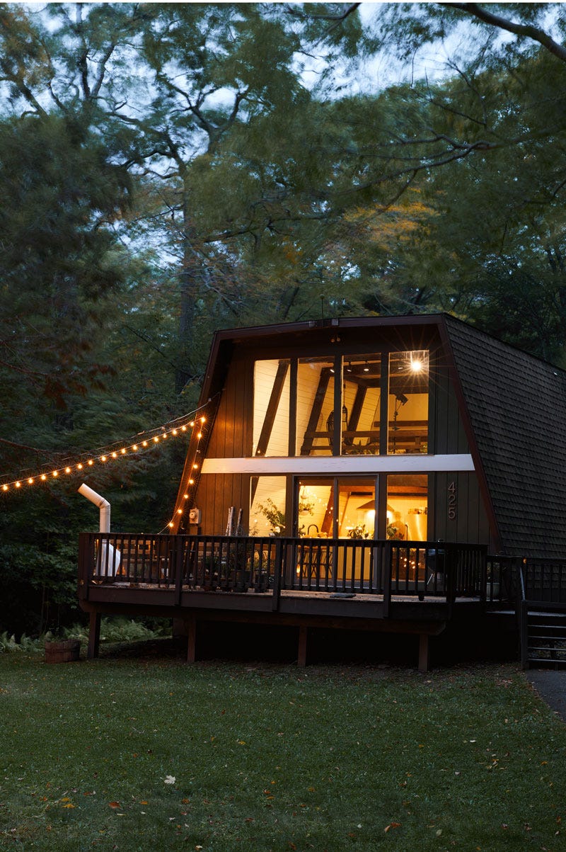 A flat-topped A-frame house seen at dusk in Tannersville, New York.