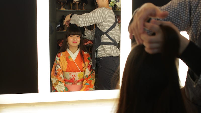A girl in a kimono gets her hair done at Nikko’s Edo Wonderland