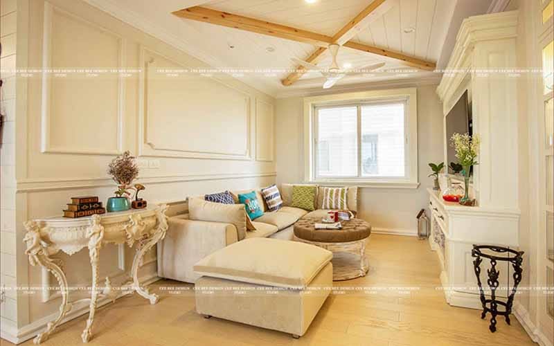 a cozy living room with white walls and rustic wooden beams.