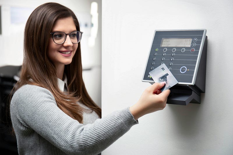 smiling lady staff holding access card over reader