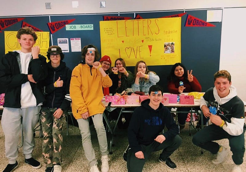Group of students standing in front of their club's table